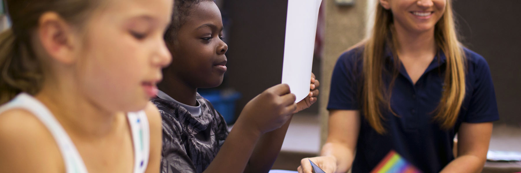 A child studies a piece of paper.